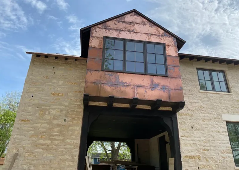 Copper metal panel facade on a stone building for Roof Repair in Payson